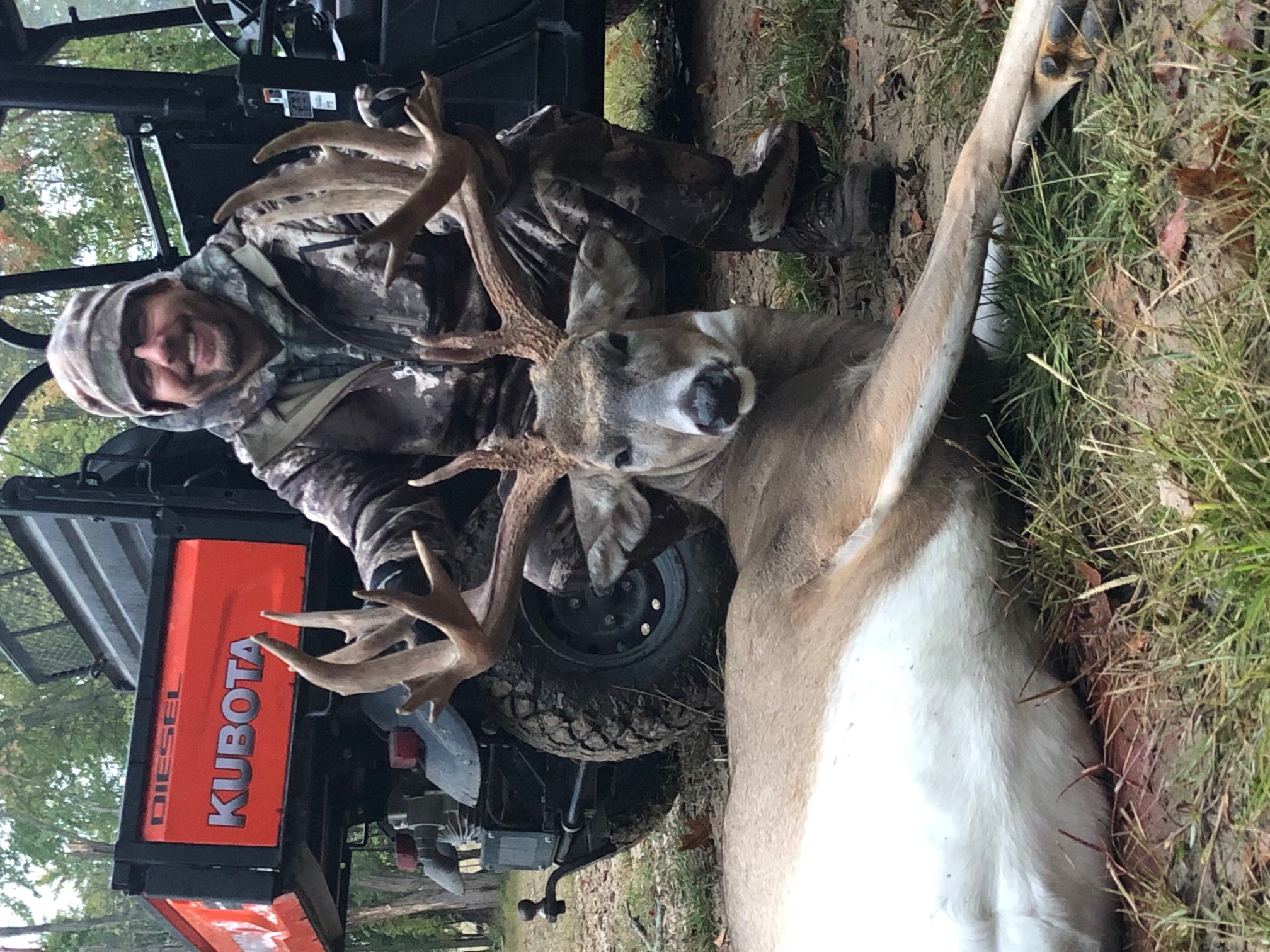 Hunter with trophy whitetail buck at Sherwood Whitetails in Michigan