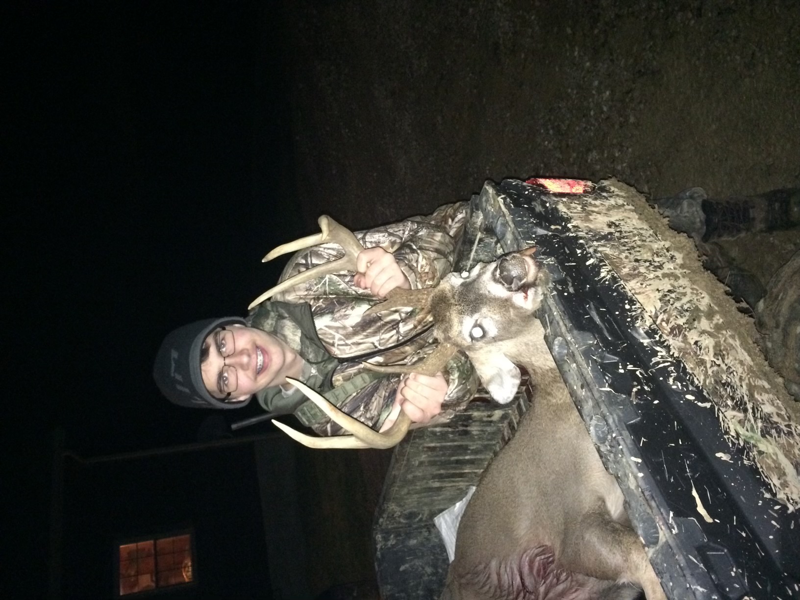 First-time hunter with guided whitetail buck at Michigan deer ranch